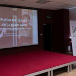 Prelegentka wygłasza referat. Na ekranie wyświetlana jest prezentacja.