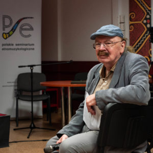 Prof. Zbigniew Jerzy Przerembski siedzi z mikrofonem w ręku